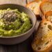 Avocado honey spread in rustic bowl with seeds and toast