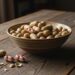 Bowl of raw little peanut on rustic kitchen table.