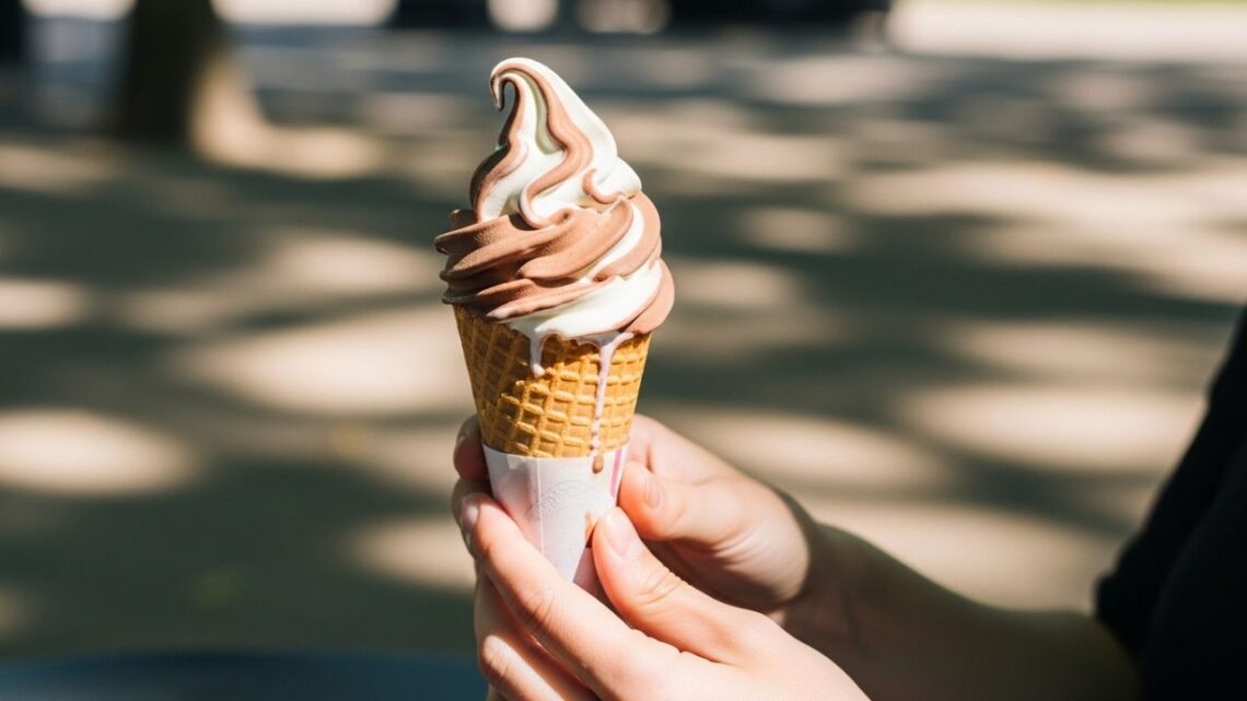 Assorted soft serve ice cream flavors in cones and cups