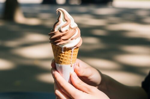 Assorted soft serve ice cream flavors in cones and cups